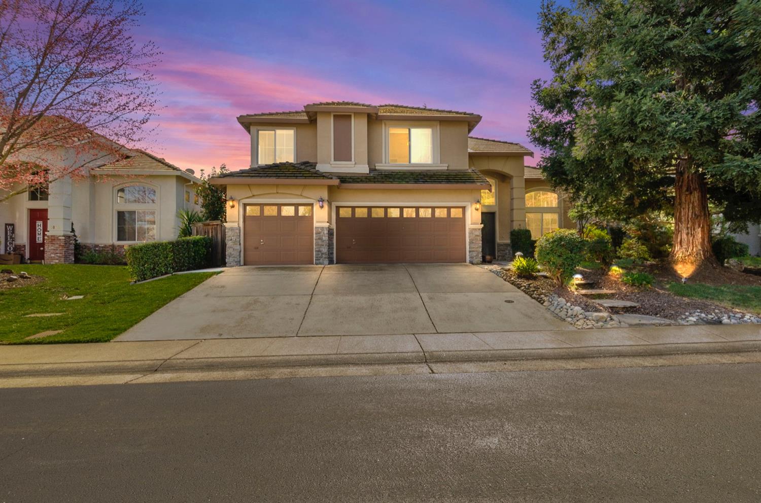 a front view of a house with a yard and garage