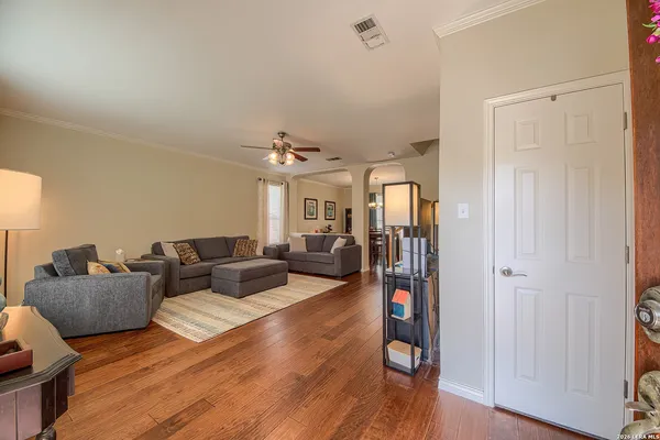 a living room with furniture and wooden floor