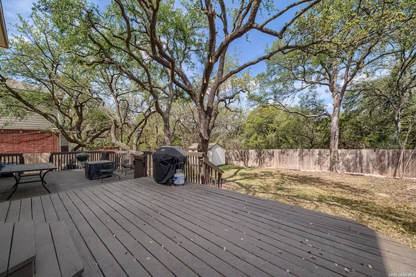 a view of a yard with wooden floor and trees