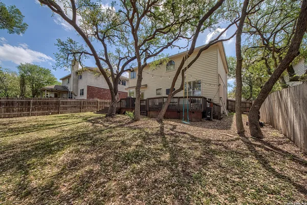 a view of a house with backyard and trees