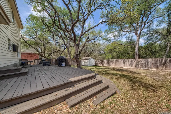 a view of a backyard with wooden fence