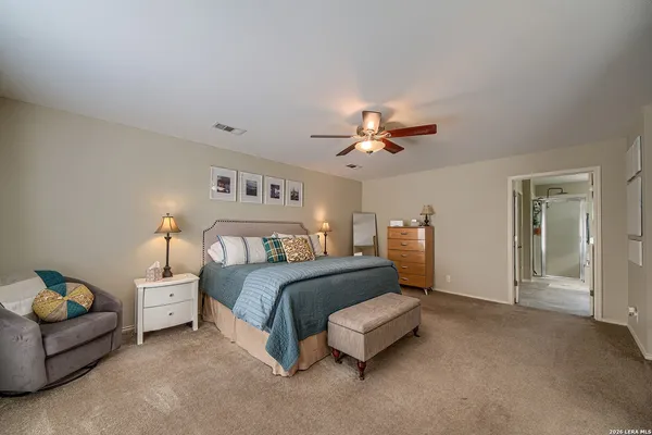 a bedroom with a bed and lamp