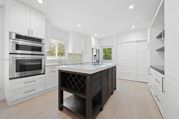 a kitchen with a sink stove and microwave