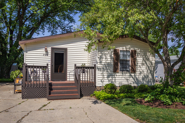 38569 North Sheridan Road, Unit 390 Beach Park, IL 60099 - Photo 1 of 28 a front view of a house with a garden