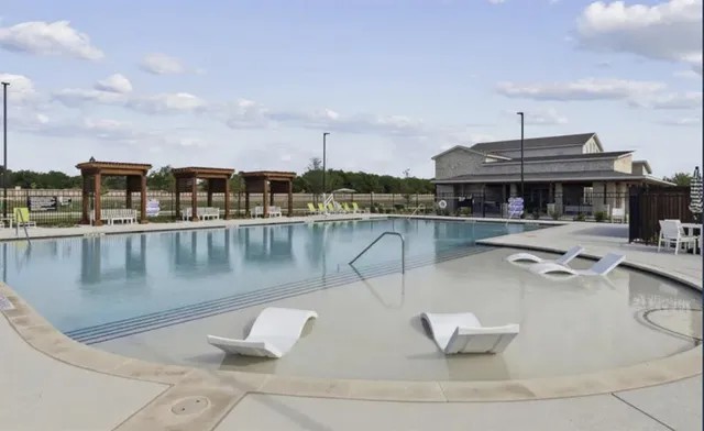a view of a swimming pool with outdoor seating
