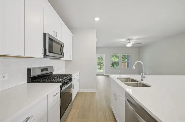 a kitchen that has a sink and a stove