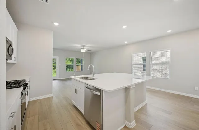 a kitchen with a sink stove and cabinets