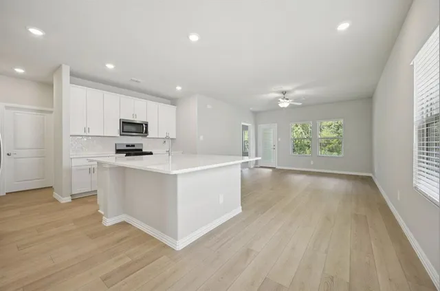 a view of kitchen with sink a microwave and refrigerator