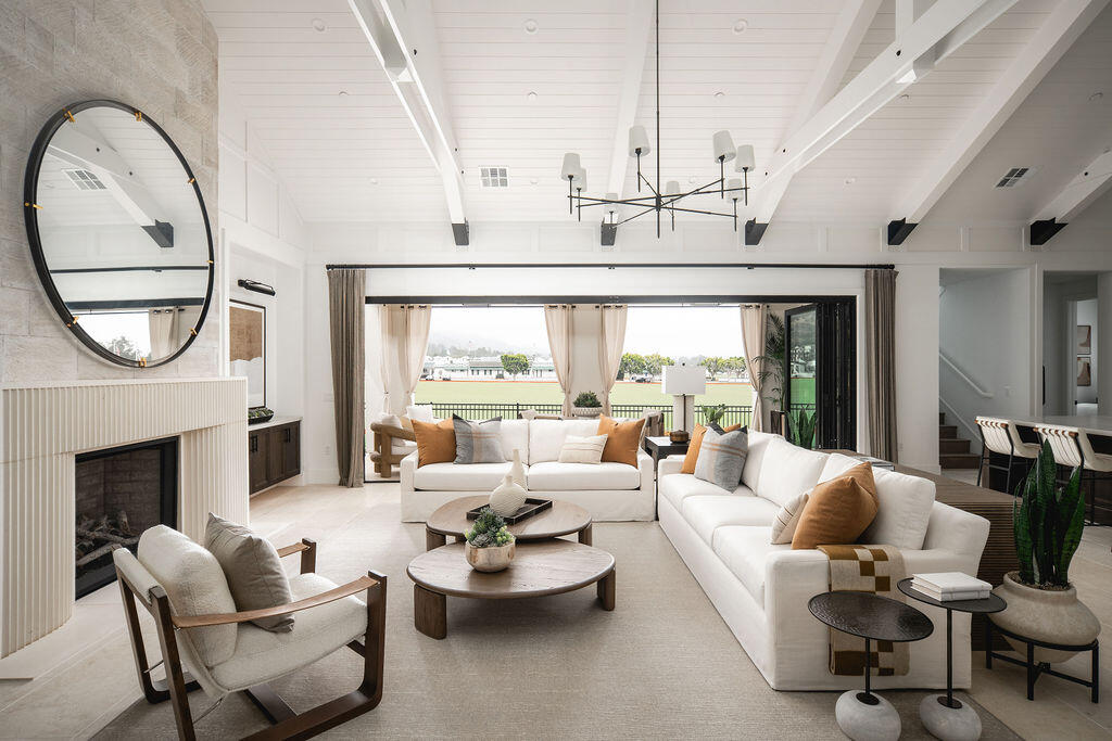 a living room with furniture a fireplace and a large window