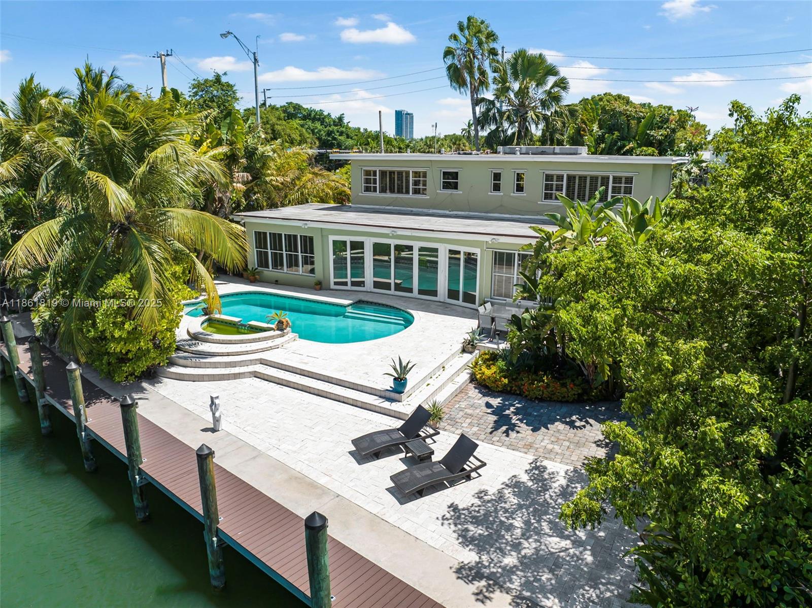 a view of a house with backyard and sitting area