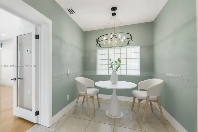 a bedroom with a large bed and a potted plant