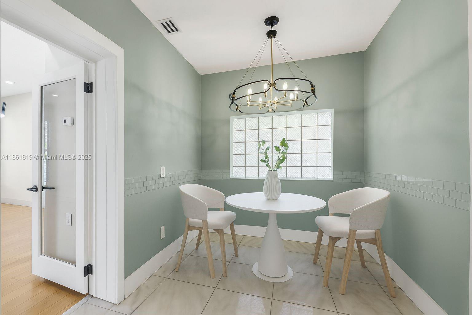 3180 North Bay Road Miami Beach, FL 33140 - Photo 16 of 41 a view of a dining room with furniture and chandelier