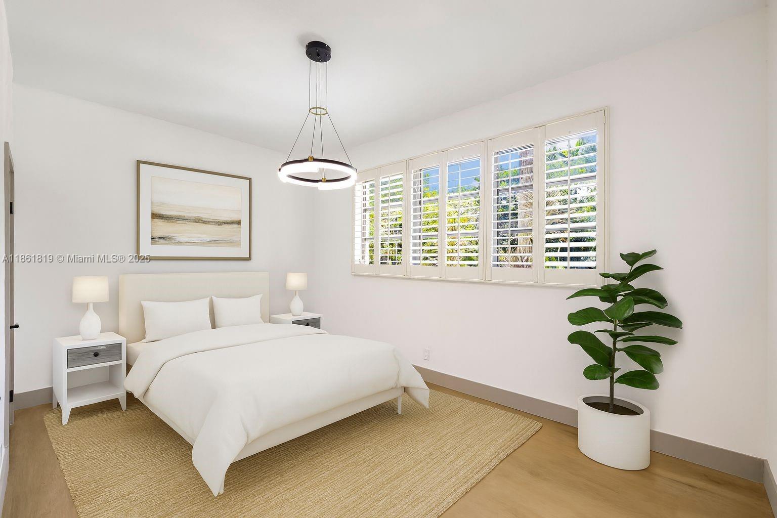 3180 North Bay Road Miami Beach, FL 33140 - Photo 17 of 41 a bedroom with a bed and a potted plant