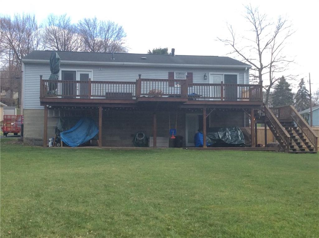 132 West McQuistion Road Butler, PA 16001 - Photo 18 of 20 REAR OF HOME - SHOWING THE GRAND 40 X 12 DECK WITH STAIRCASE TO SPACIOUS BACK YARD. ALSO, LL WALK OUT TO COVERED PATIO.