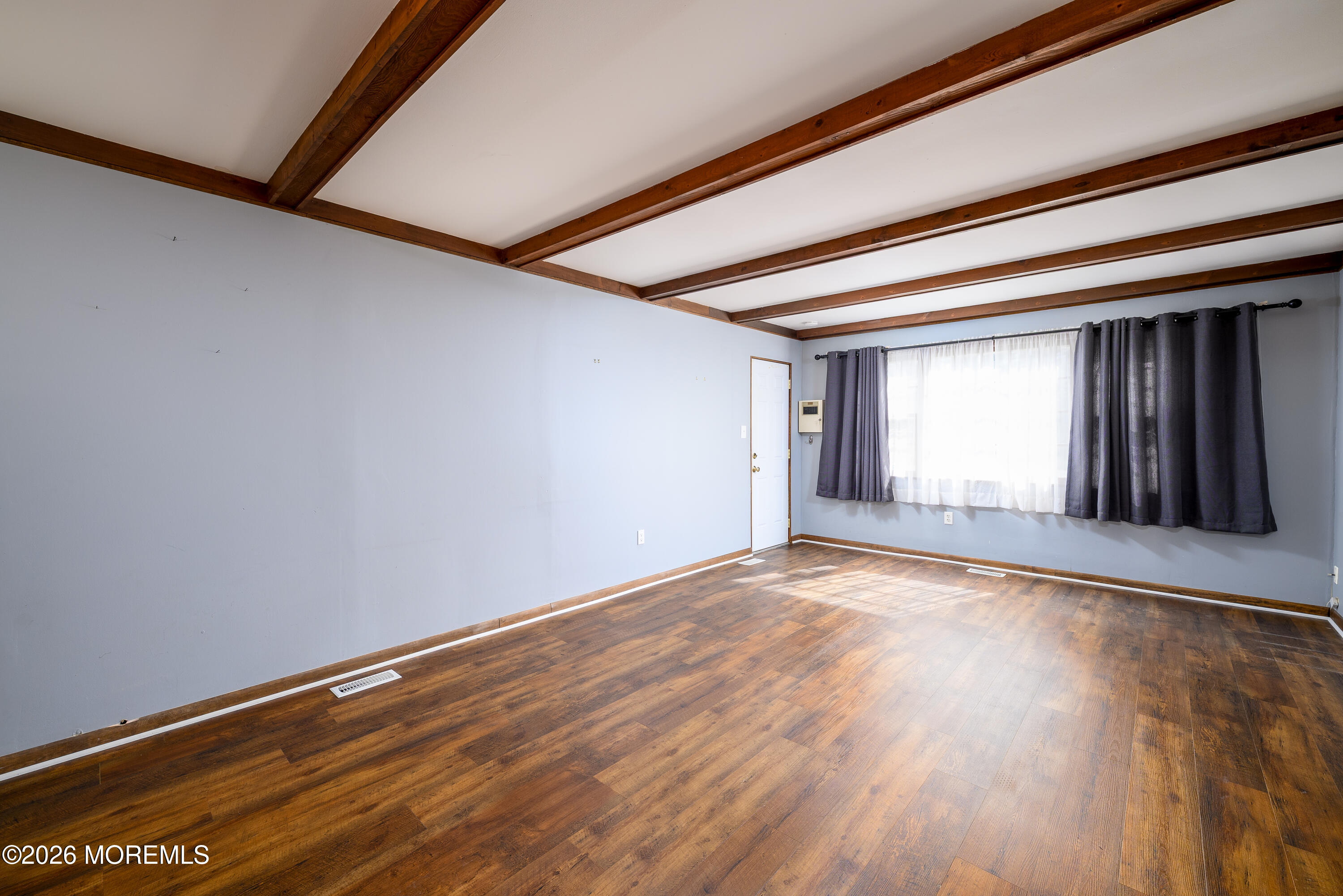 821 Middletown-Lincroft Road Middletown, NJ 07748 - Photo 11 of 42 a view of an empty room with wooden floor and a window