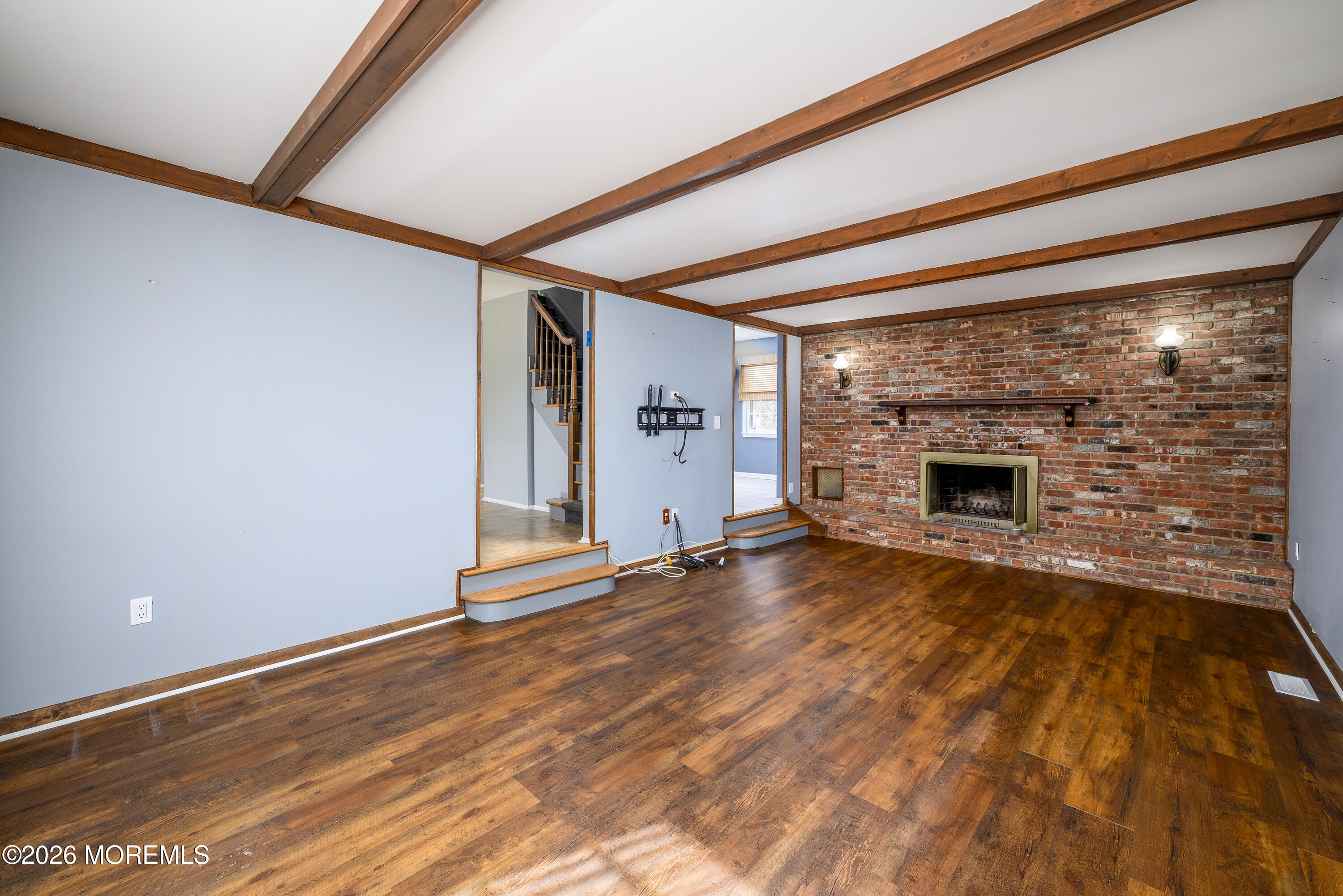 821 Middletown-Lincroft Road Middletown, NJ 07748 - Photo 12 of 42 a view of empty room with wooden floor and fireplace