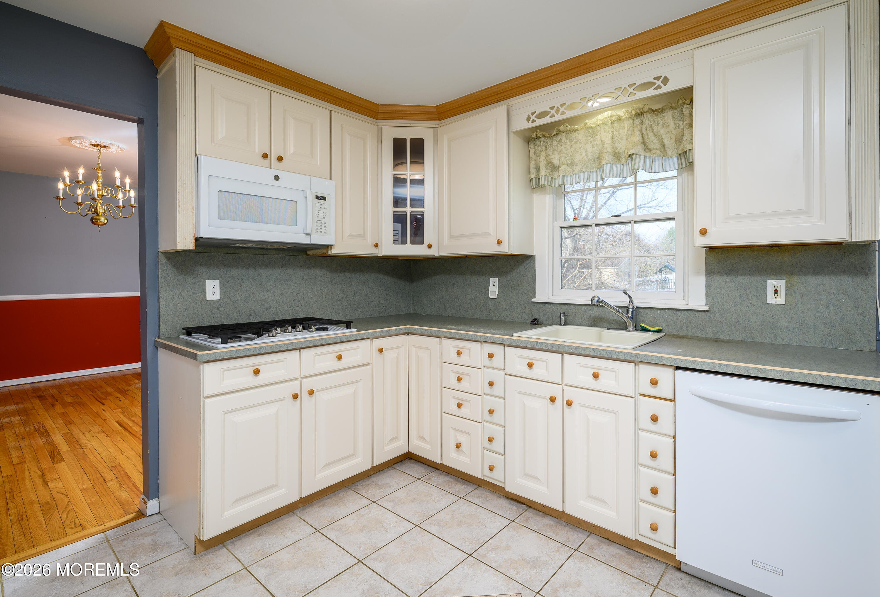 821 Middletown-Lincroft Road Middletown, NJ 07748 - Photo 15 of 42 a kitchen with granite countertop white cabinets stainless steel appliances a sink and a window