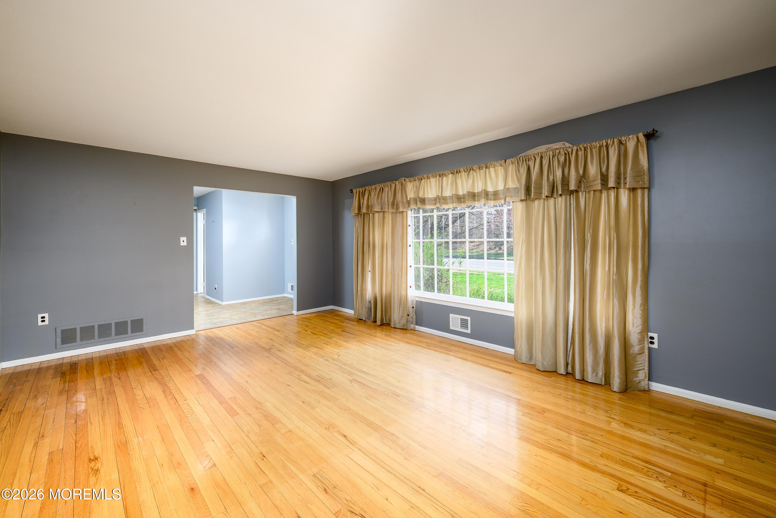 821 Middletown-Lincroft Road Middletown, NJ 07748 - Photo 22 of 42 a view of an empty room with wooden floor and a window