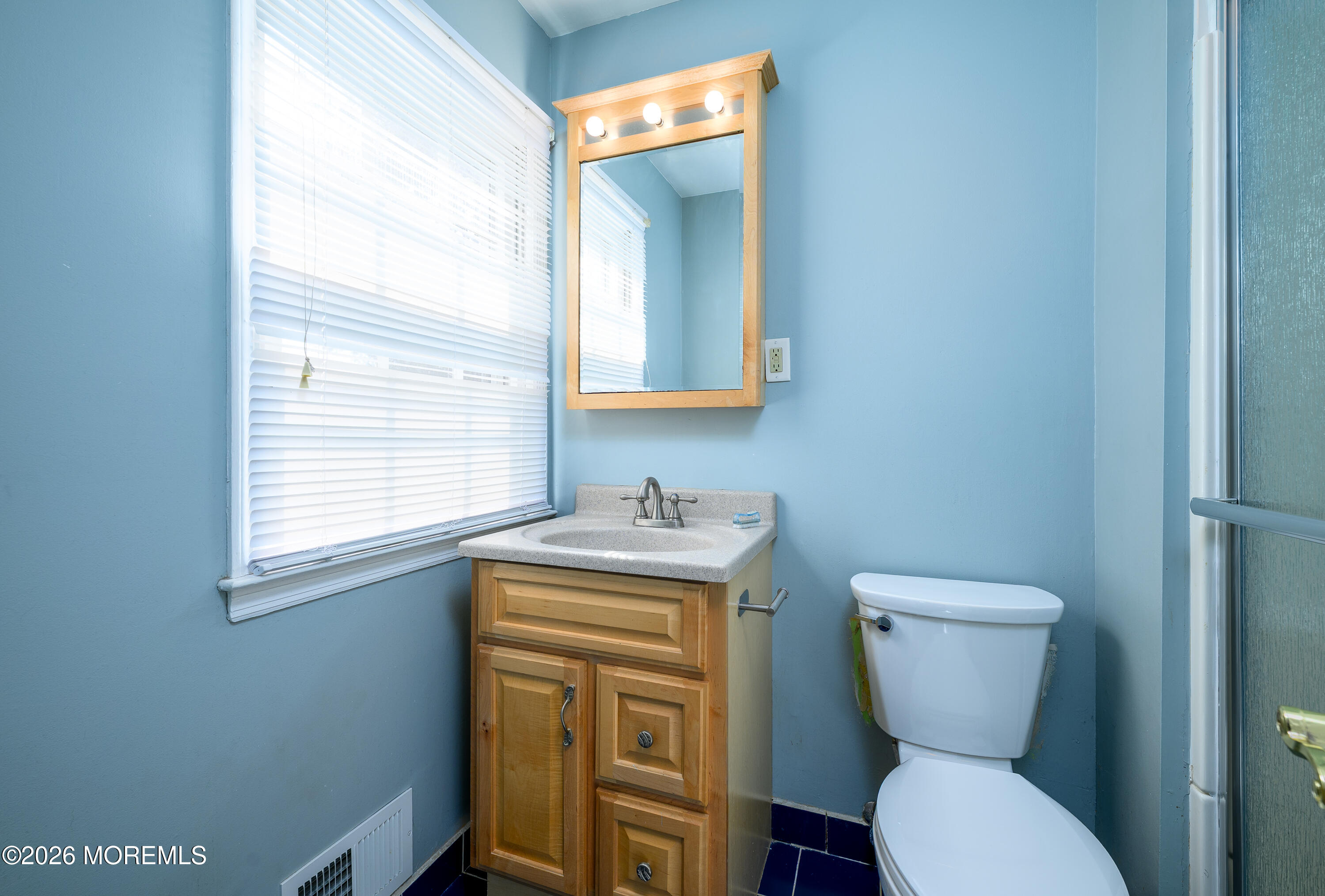 821 Middletown-Lincroft Road Middletown, NJ 07748 - Photo 26 of 42 a bathroom with a toilet a sink and a window