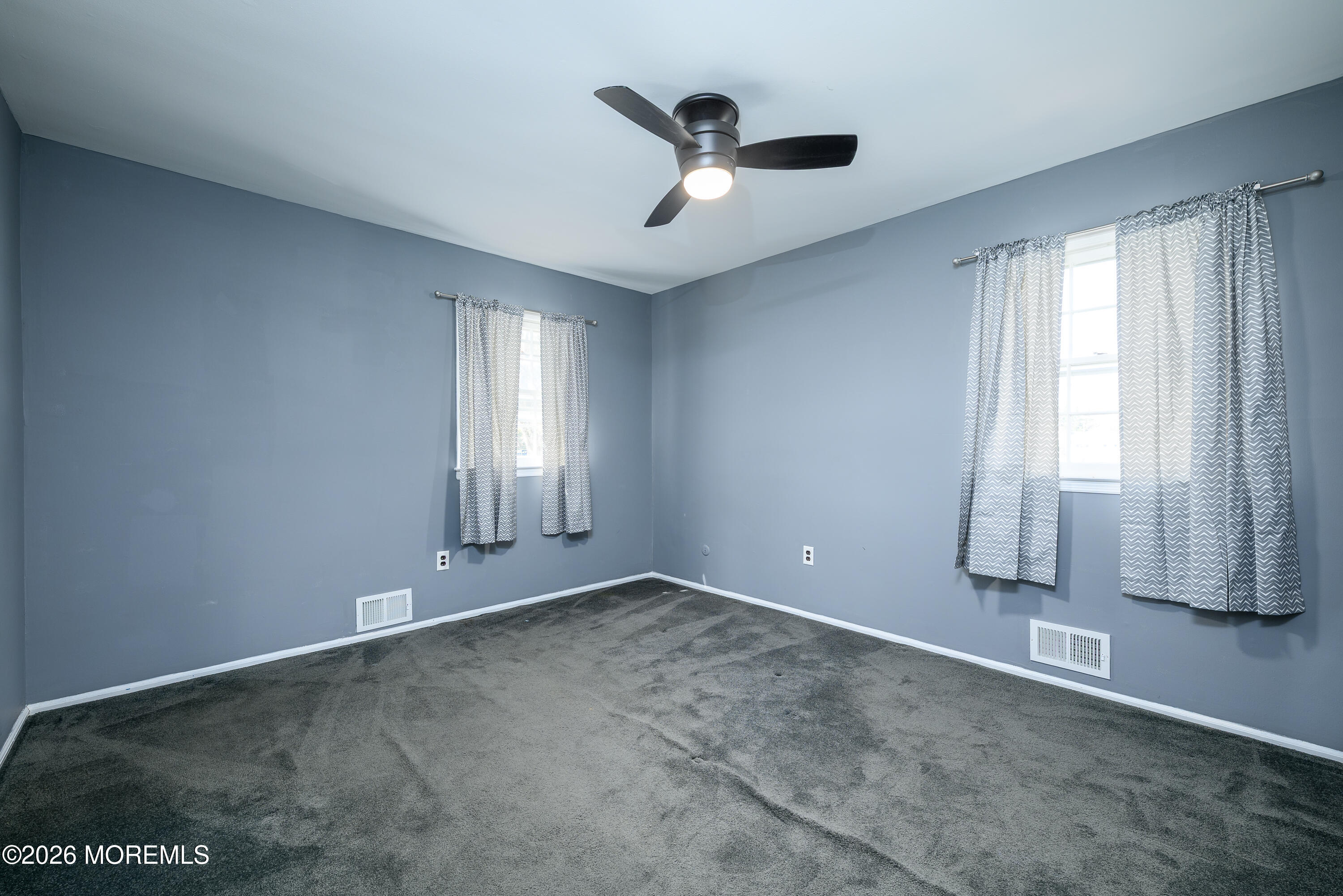 821 Middletown-Lincroft Road Middletown, NJ 07748 - Photo 27 of 42 an empty room with windows and ceiling fan