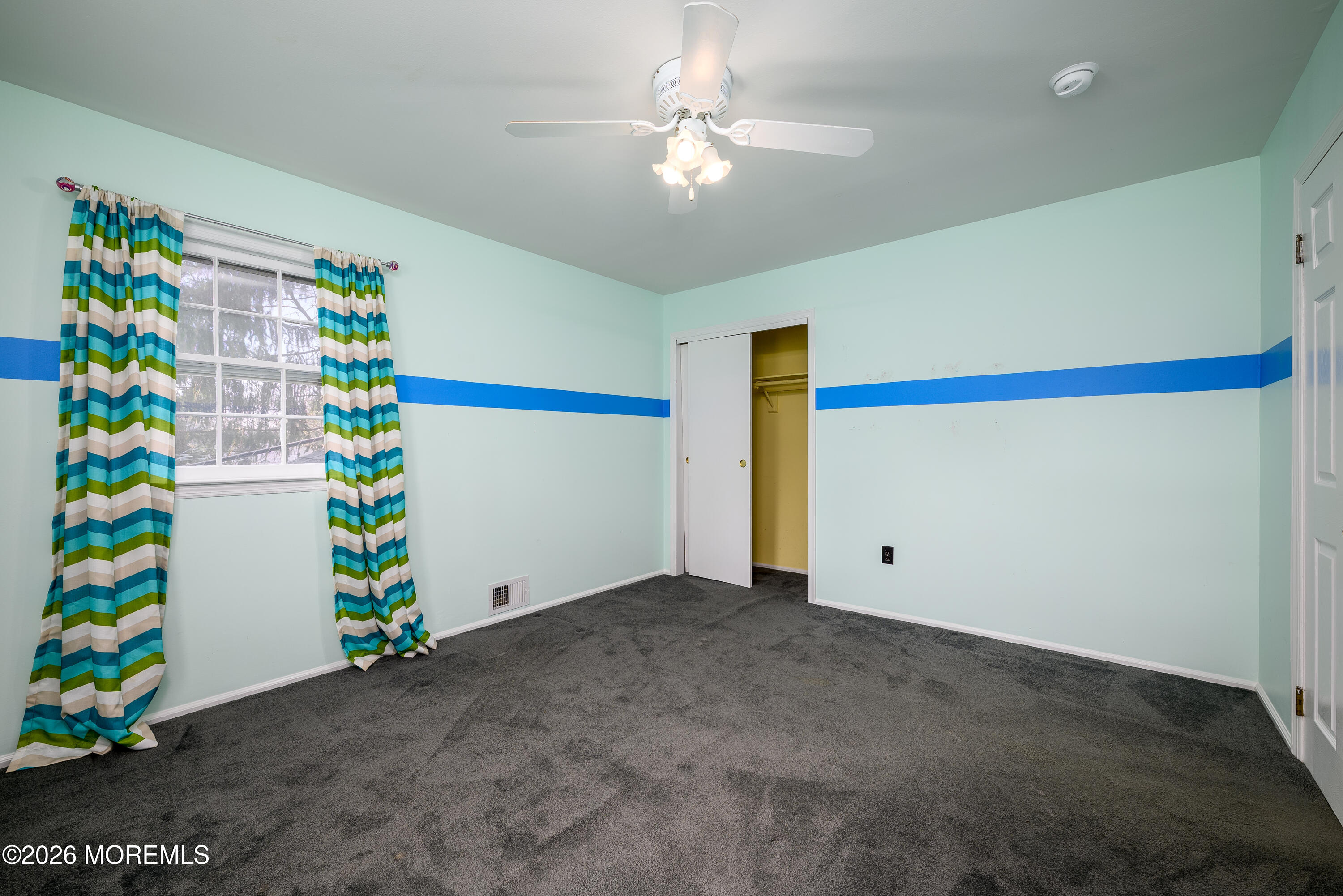 821 Middletown-Lincroft Road Middletown, NJ 07748 - Photo 30 of 42 a room with flowers and ceiling fan