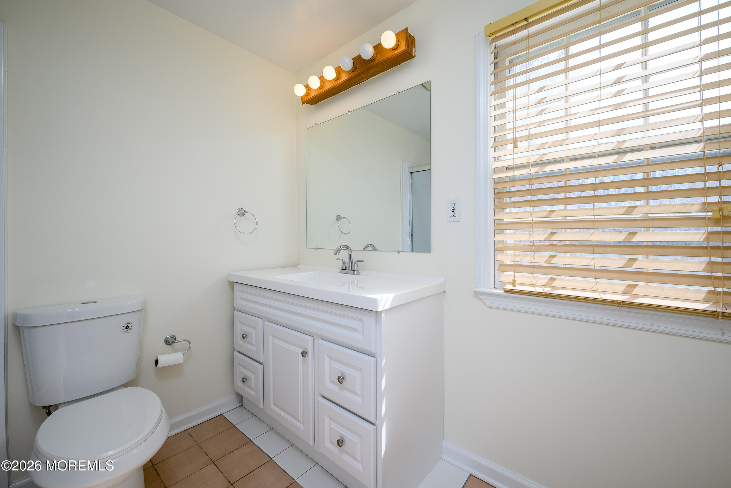 821 Middletown-Lincroft Road Middletown, NJ 07748 - Photo 32 of 42 a bathroom with a sink a toilet and a mirror