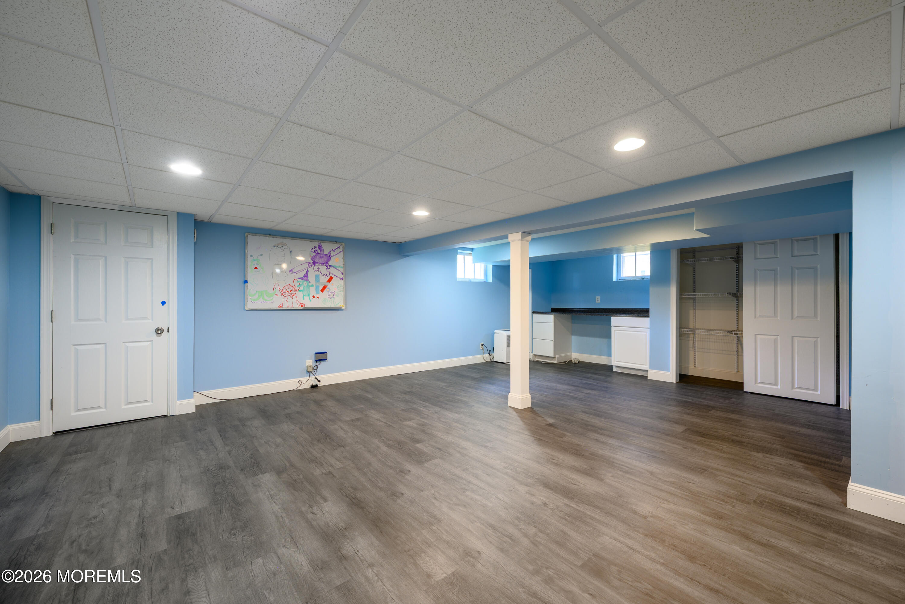 821 Middletown-Lincroft Road Middletown, NJ 07748 - Photo 34 of 42 an empty room with wooden floor fireplace and window