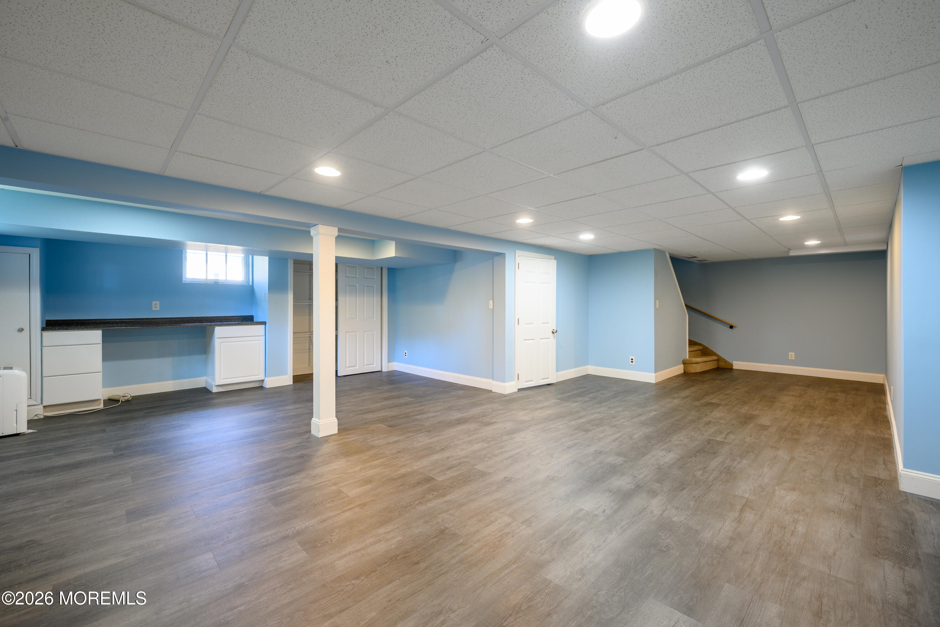 821 Middletown-Lincroft Road Middletown, NJ 07748 - Photo 35 of 42 an empty room with wooden floor and fireplace