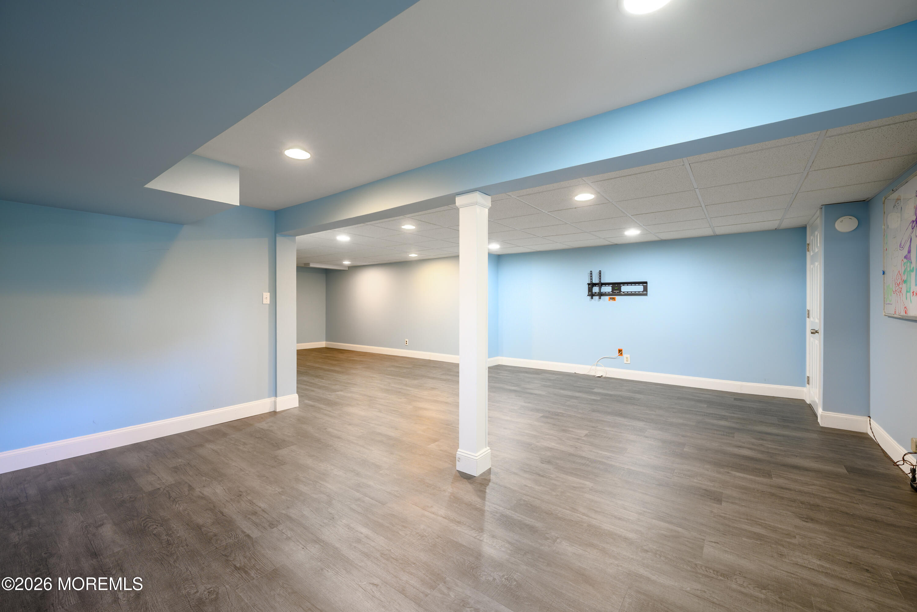 821 Middletown-Lincroft Road Middletown, NJ 07748 - Photo 37 of 42 an empty room with wooden floor and windows