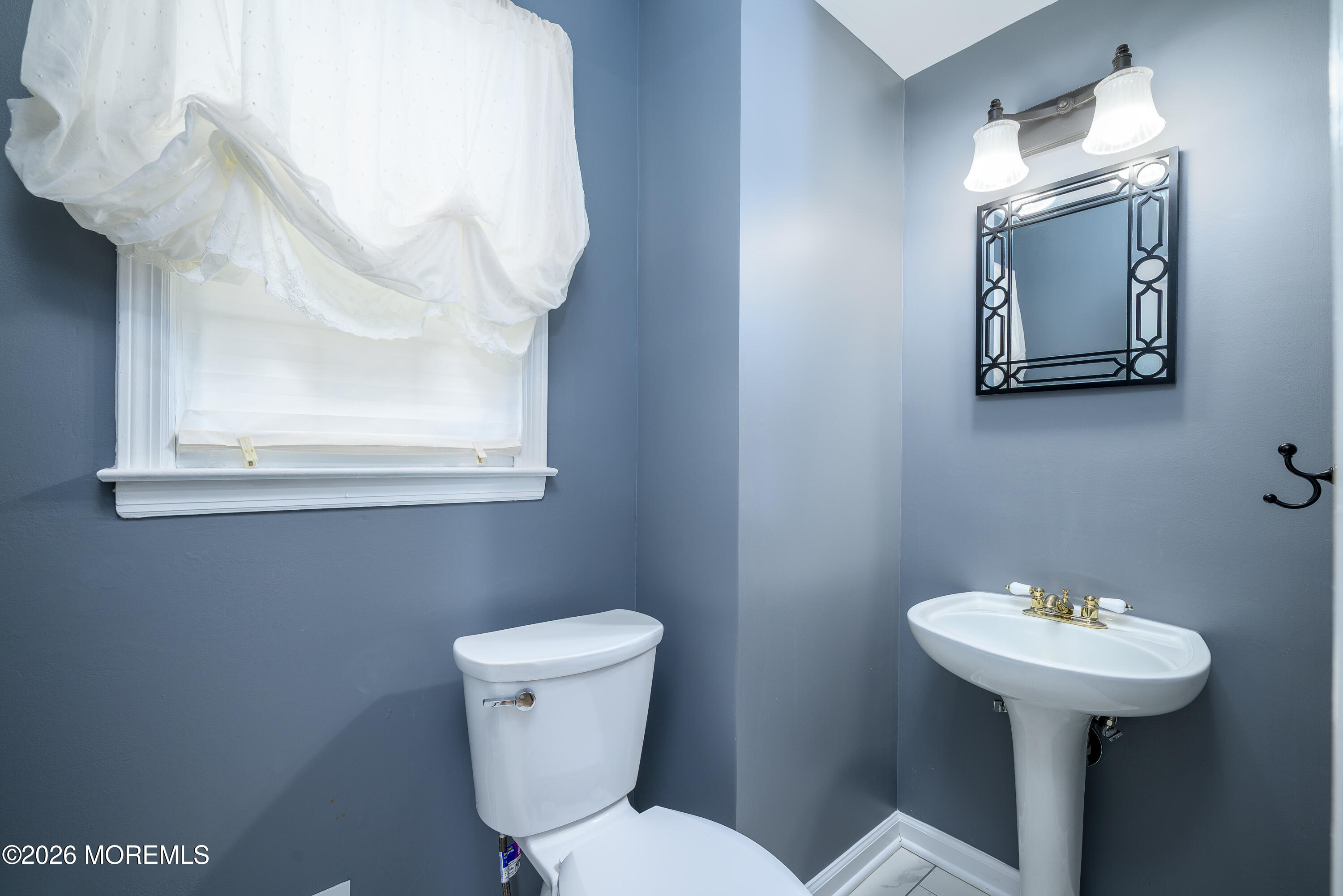 821 Middletown-Lincroft Road Middletown, NJ 07748 - Photo 10 of 42 a bathroom with a toilet sink and mirror