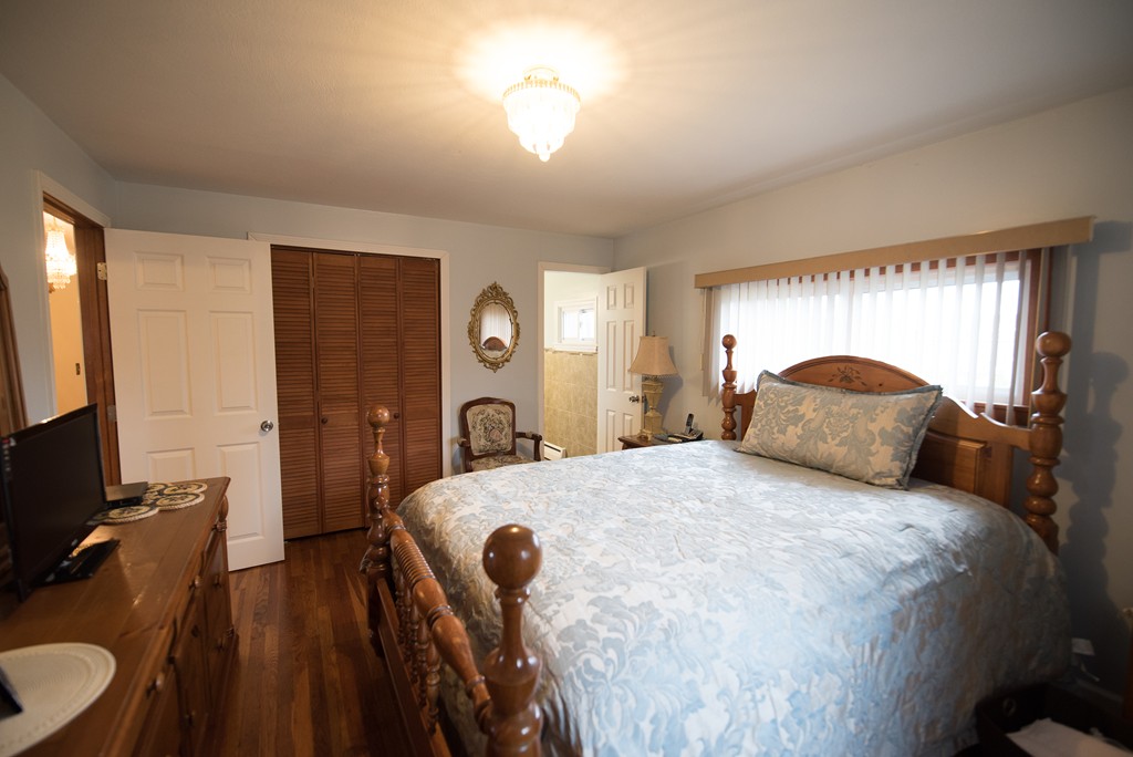 362 Stapleton Road Springfield, MA 01109 - Photo 14 of 24 a bedroom with a bed and a flat tv screen on dresser