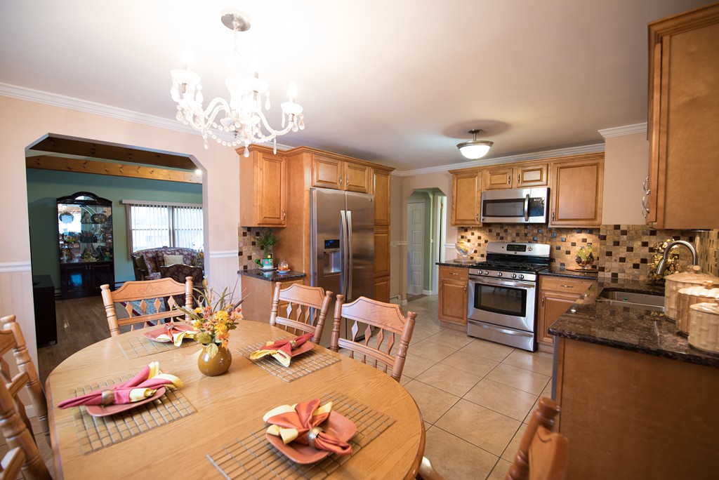 362 Stapleton Road Springfield, MA 01109 - Photo 7 of 24 a large kitchen with a table and chairs