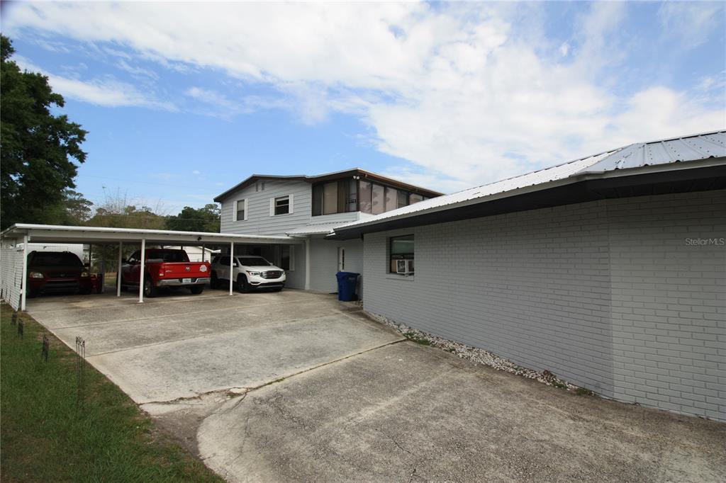 521 20th Street Southwest, Unit C Winter Haven, FL 33880 - Photo 14 of 18 a view of a car park in front of a house
