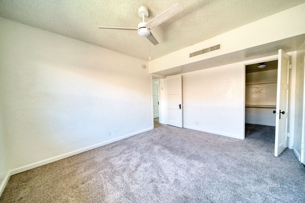 137 South Richmond Road Ridgecrest, CA 93555 - Photo 24 of 31 an empty room with a ceiling fan and carpet