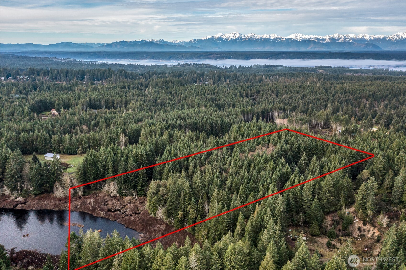51 East Carols Place Belfair, WA 98528 - Photo 3 of 14 a view of a lake with a mountain in the background