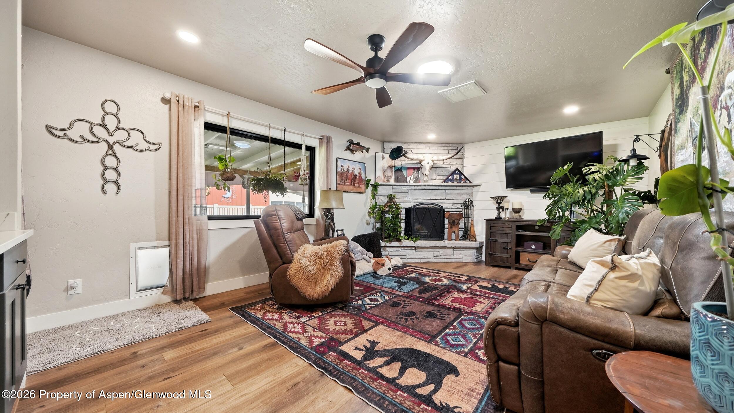 445 South Camp Road Grand Junction, CO 81507 - Photo 15 of 37 a living room with furniture a fireplace and a large window
