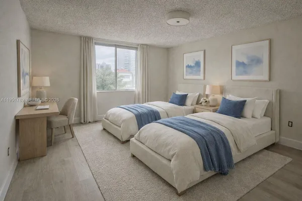 a spacious bedroom with two beds and a couch