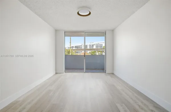 a view of an empty room with a window