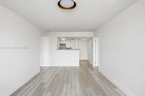 a view of a kitchen with wooden floor and a sink