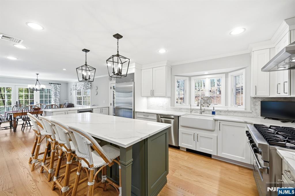 760 Rivenwood Road Franklin Lakes, NJ 07417 - Photo 12 of 48 a large kitchen with granite countertop a stove a sink a dining table and chairs