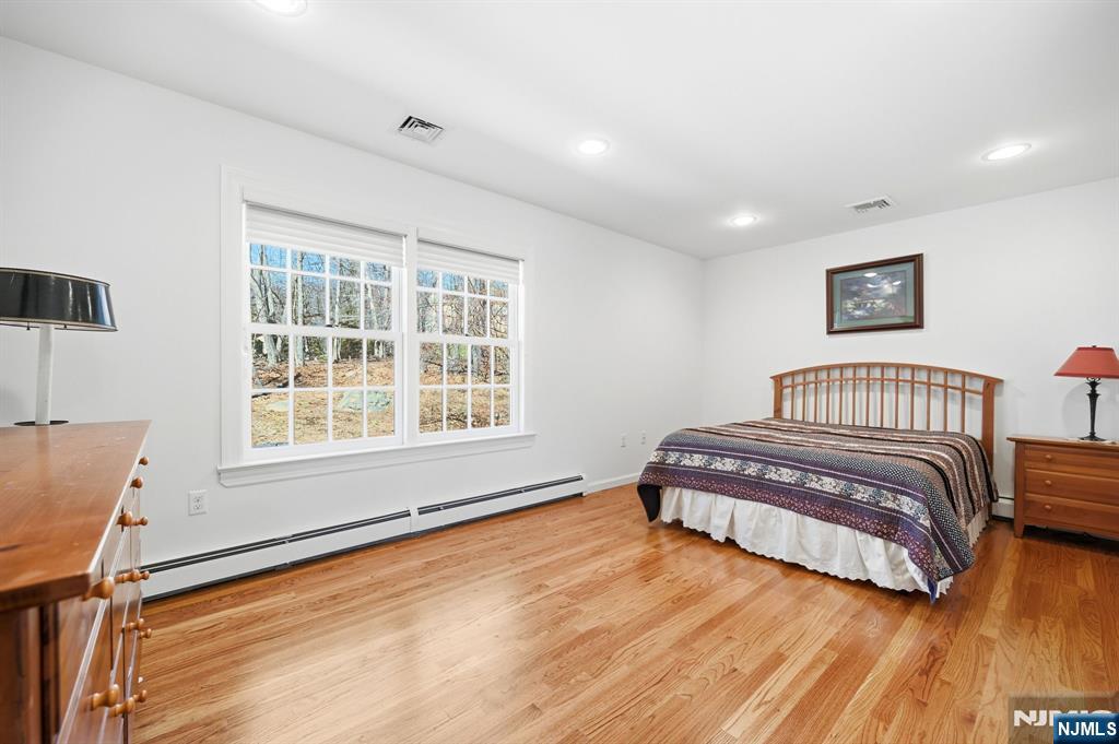 760 Rivenwood Road Franklin Lakes, NJ 07417 - Photo 20 of 48 a bedroom with a bed and wooden floor