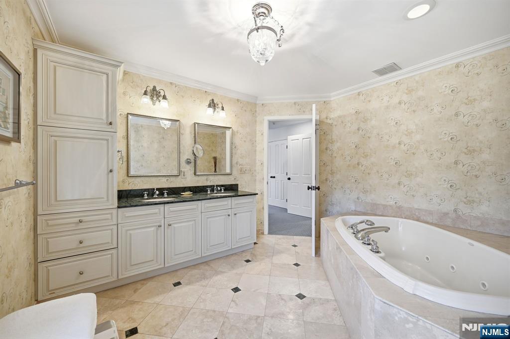 760 Rivenwood Road Franklin Lakes, NJ 07417 - Photo 22 of 48 a bathroom with a bathtub sink and mirror