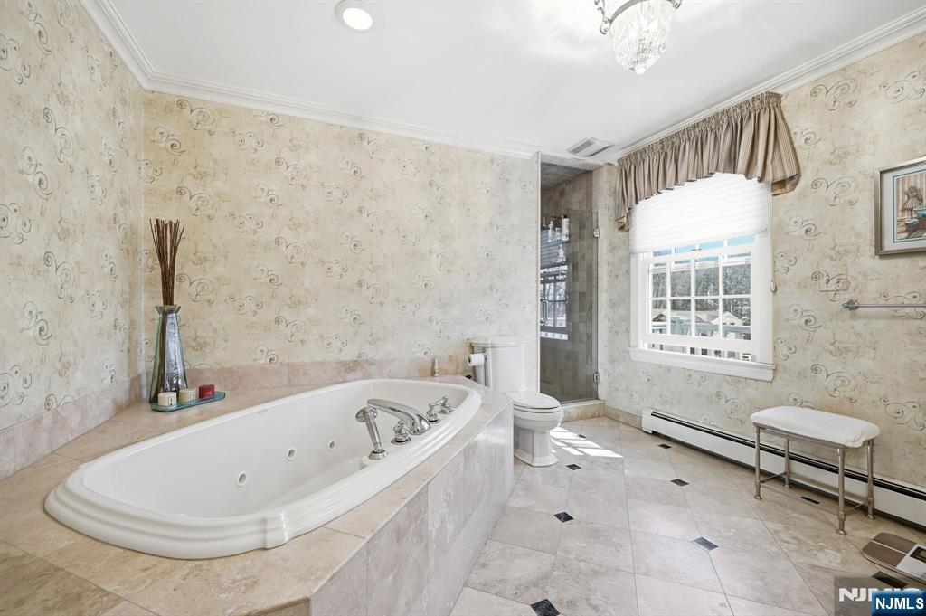 760 Rivenwood Road Franklin Lakes, NJ 07417 - Photo 23 of 48 a bathroom with a bathtub and window