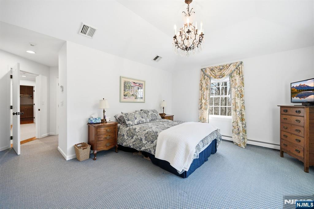 760 Rivenwood Road Franklin Lakes, NJ 07417 - Photo 24 of 48 a spacious bedroom with a bed and a window