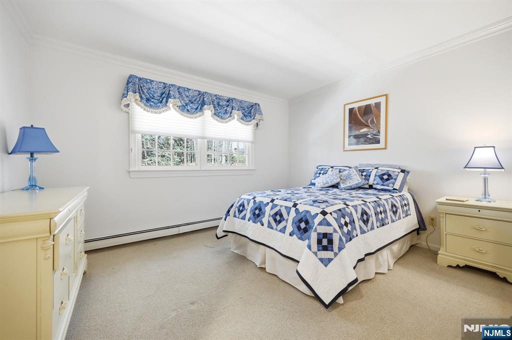 760 Rivenwood Road Franklin Lakes, NJ 07417 - Photo 27 of 48 a spacious bedroom with a bed and a window