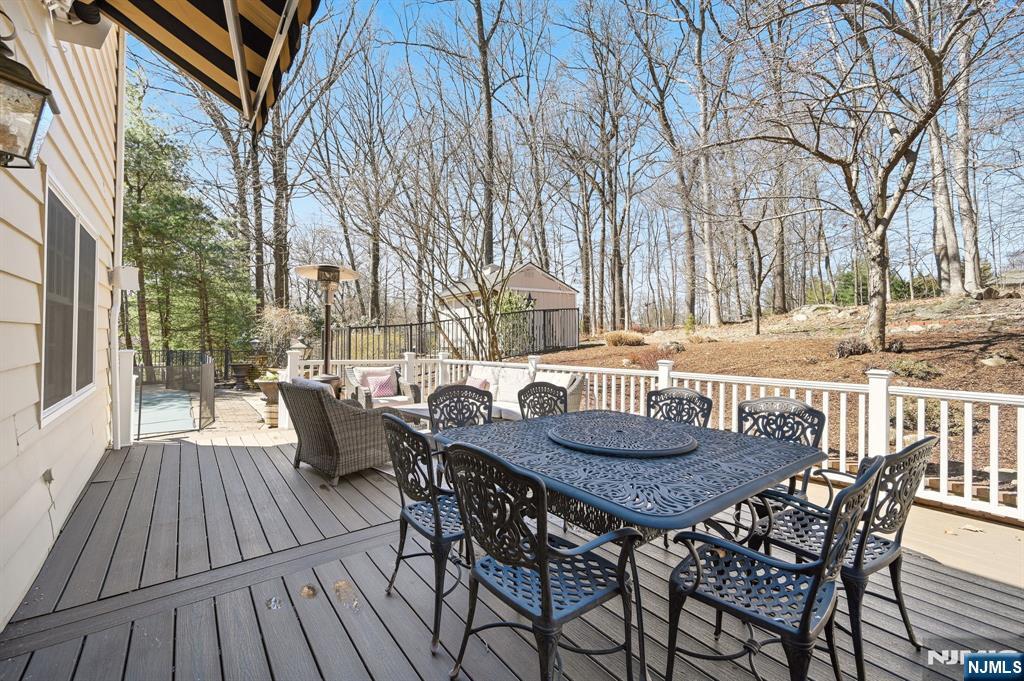 760 Rivenwood Road Franklin Lakes, NJ 07417 - Photo 33 of 48 a view of a patio with a table and chairs