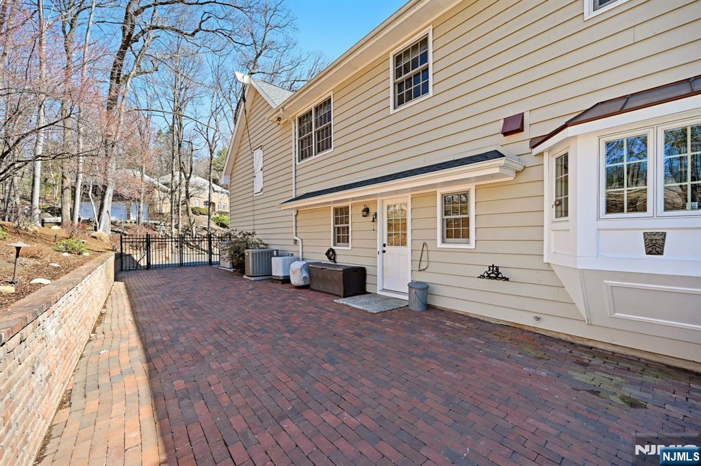 760 Rivenwood Road Franklin Lakes, NJ 07417 - Photo 41 of 48 a view of a house with a barbeque and wooden stairs