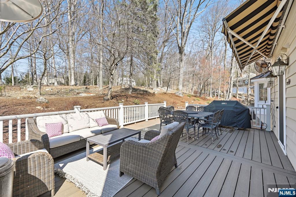 760 Rivenwood Road Franklin Lakes, NJ 07417 - Photo 43 of 48 a view of a patio with couches and table and chairs with wooden floor