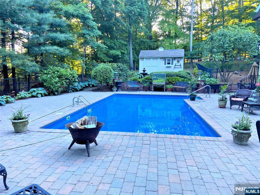 760 Rivenwood Road Franklin Lakes, NJ 07417 - Photo 48 of 48 a swimming pool with outdoor seating and yard