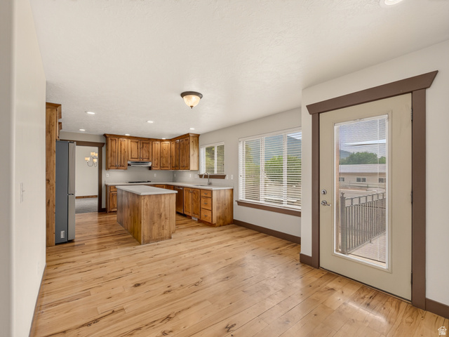 1279 West 1500th Street North Mapleton, UT 84664 - Photo 28 of 83 Kitchen featuring light wood-finish flooring, wood cabinetry, a central island with a light-toned countertop, and recessed lighting